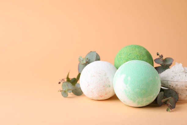 istock Colorful bath bombs, salt and eucalyptus branches on beige background, space for text 1322989726