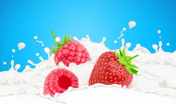 istock Strawberry and raspberry in milk splashes isolated on a blue background. 1322990299