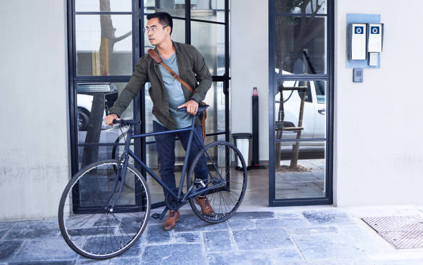 istock Shot of a young man using a bicycle in the city 1322990440