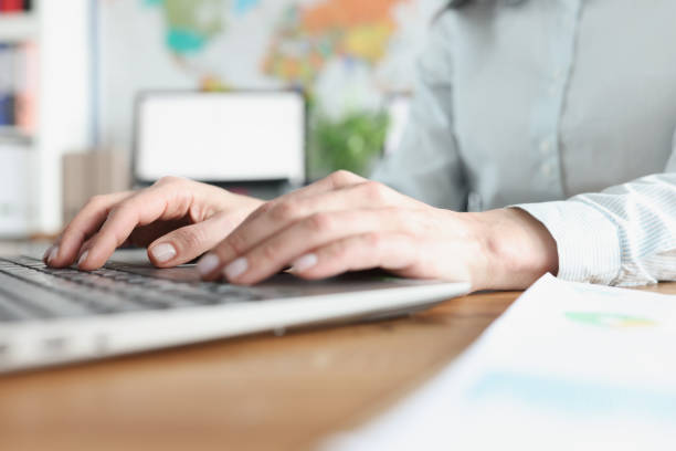 istock Female hands typing on laptop keyboard in office closeup 1322990561