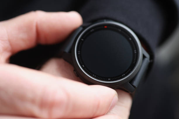 Man pressing button on black smart watch closeup. Sale of fitness bracelets concept