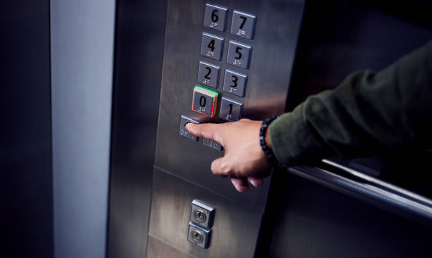 Shot of an unrecognizable man pressing a button in an elevator
