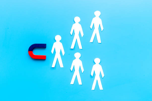 istock Corporate menegement team concept with horseshoe magnet and human figures 1322990897