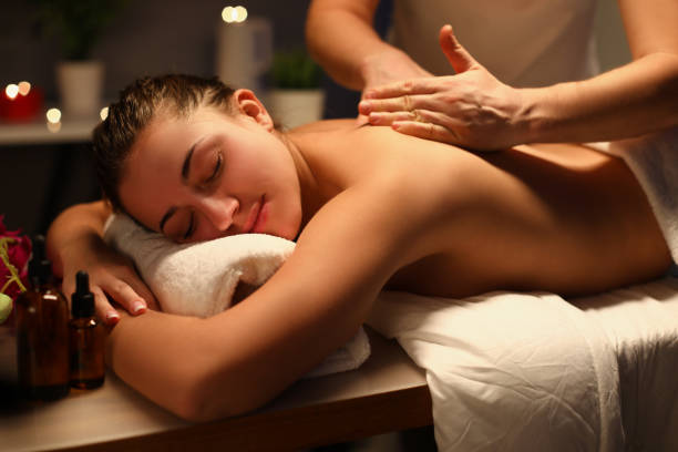 istock Young woman relaxing during back massage at spa 1322991053
