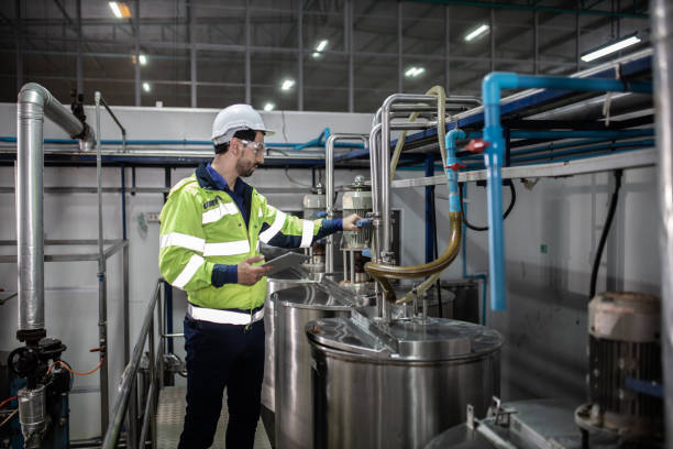 istock Engineer in uniform holding a tablet in her hands and conducting an inspection at the machine in Factory. Industrial production concept 1322993563