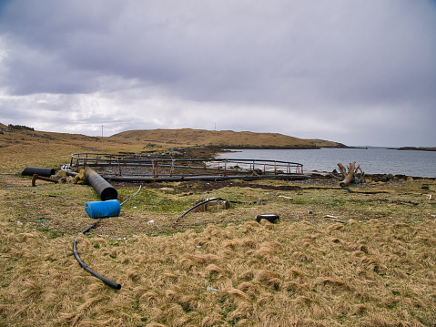 Abandoned plastic fish farming pens and other material connected to aquaculture - taken at West Voe on the island of Housay, Out Skerries, Shetland, UK
