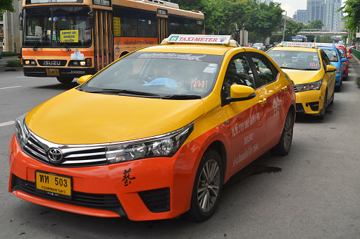 Bangkok, Thailand- May 13, 2017: Taxi driver waiting for passenger in Bangkok, Thailand. There are 150,000 taxis in Bangkok.