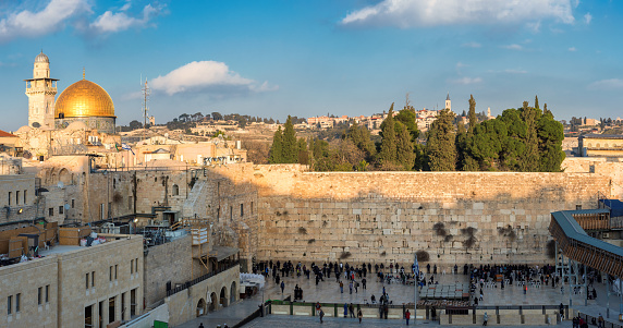 Panoramic view in the old city of Jerusalem at sunset, including the Western Wall and golden Dome of the Rock, Jerusalem, Israel.