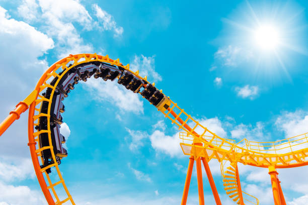 roller coaster high in the summer sky at theme park most excited fun and joyful playing machine roller coaster high in the summer sky at theme park most excited fun and joyful playing machine fairground ride stock pictures, royalty-free photos & images