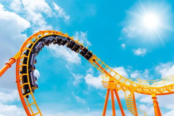Photo of roller coaster high in the summer sky at theme park most excited fun and joyful playing machine