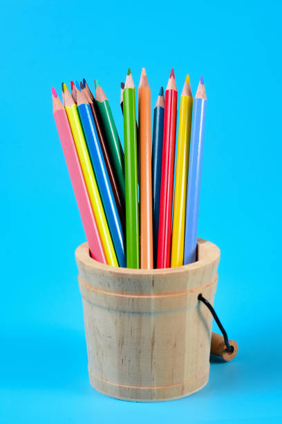 istock Colored pencils on the table. Color pencils on blue background. 1323000673