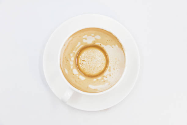 istock Empty cup of coffee with sediment on white background 1323002133
