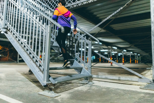 istock Woman running up stairs 1323002138