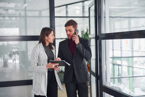 istock Two office workers in formal clothes indoors have a busy working day 1323003014