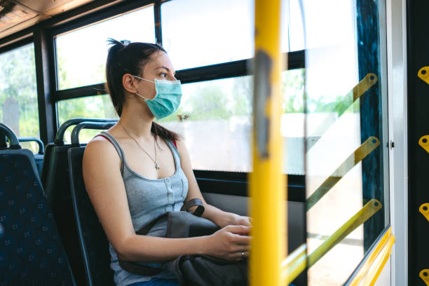 istock Woman in bus wearing face mask 1323003102