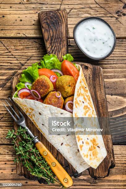 Vegetarian Tortilla Wrap With Falafel And Fresh Salad Vegan Tacos Wooden Background Top View Stock Photo - Download Image Now