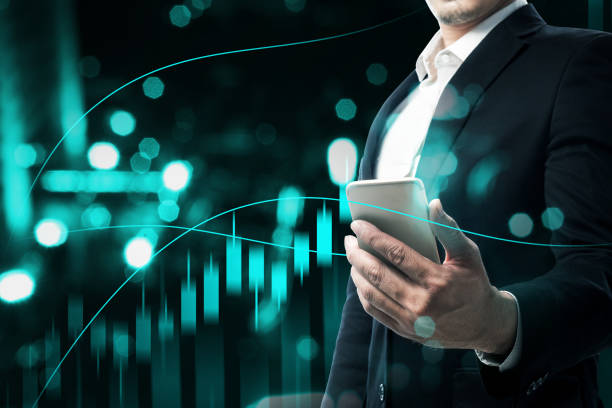 istock Businessman with mobile phone showing a dollar virtual bar chart 1323007332