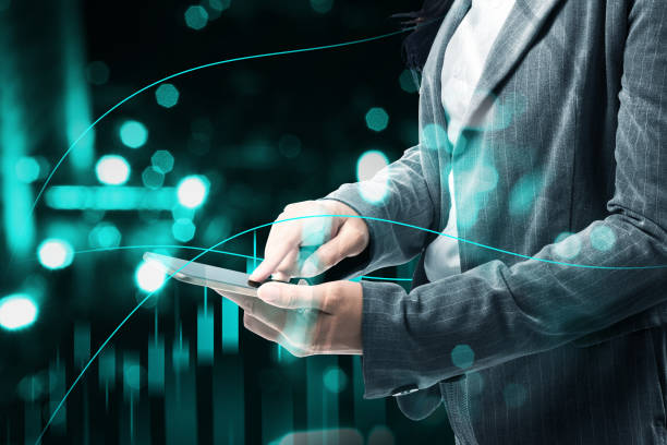 istock Businesswoman with mobile phone showing a dollar virtual bar chart 1323007352