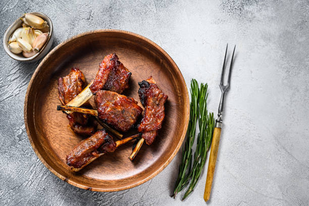 istock BBQ grilled sliced lamb short spare loin ribs. White background. Top view. Copy space 1323009631
