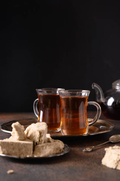 istock Tea ceremony with halva on dark. Close up. 1323010513