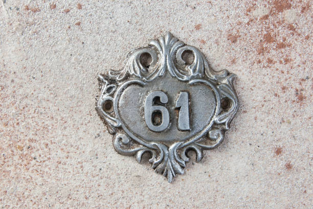istock Old aluminum number on concrete background 1323010860