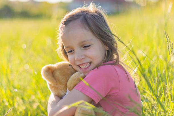 istock Girl embracing teddy bear 1323010969