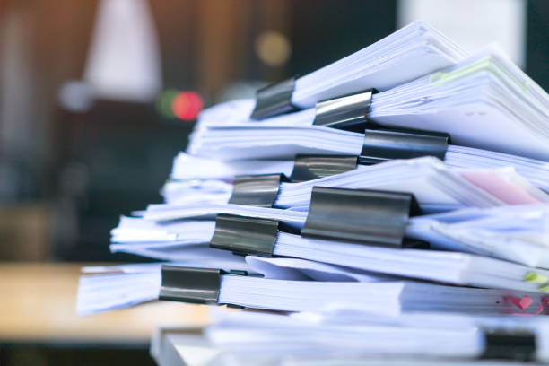 istock Business paper in offices working for arranging documents unfinished stack of document papers with pen, clip papers on busy office desk, Accounting planning budget concept 1323011654