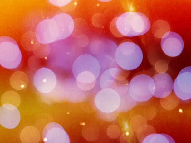 istock purple glowing round blurred lights with orange glow and vibrant bright sparkle effect 1323013525