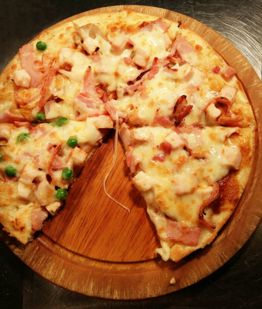 istock Cut into slices delicious fresh pizza 1323013889