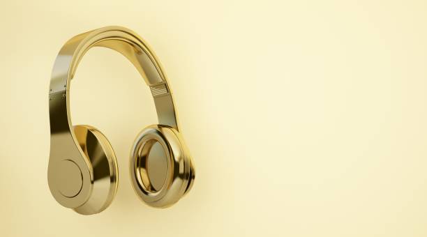istock gold headphones on yellow background 1323013958