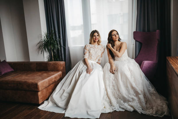 Two beautiful young women in wedding dresses