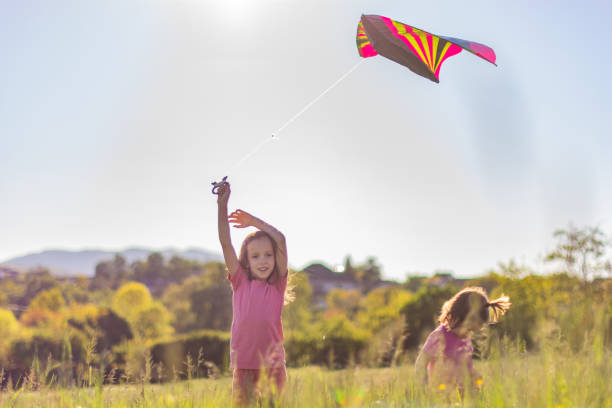 istock Two girls playing in the meadow 1323014676