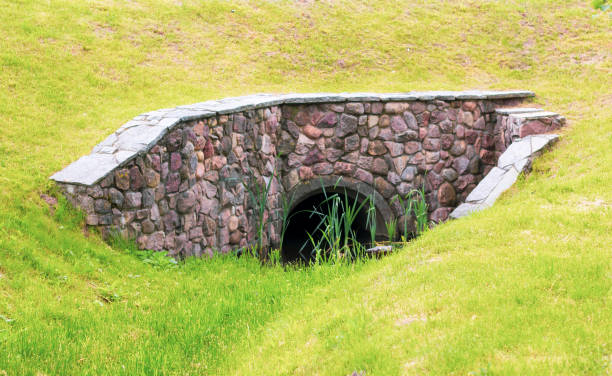 istock A small stone tunnel under a grassy road. Summer day 1323017393