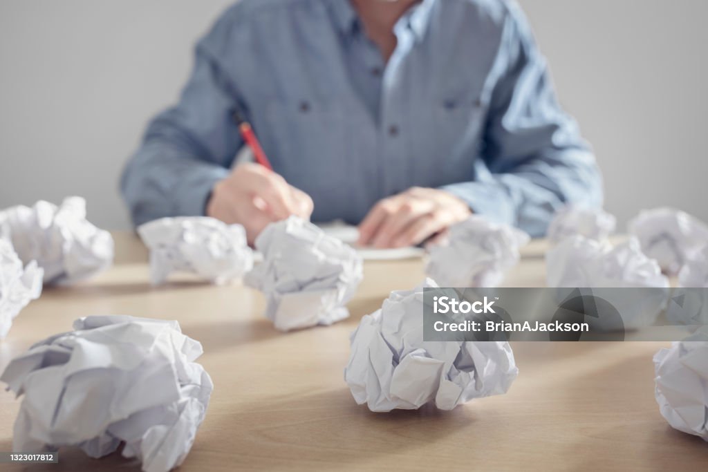 Frustration stress and writers block Frustration stress and writers block, business man with crumpled paper balls in a pile Paper Stock Photo