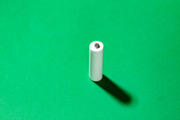 istock White AA batteries on a green background. Space for text. 1323019048