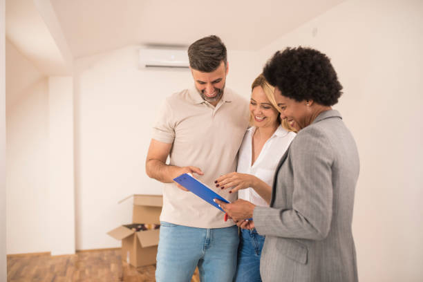 istock Happy couple checking the contract while buying a new apartment 1323020016