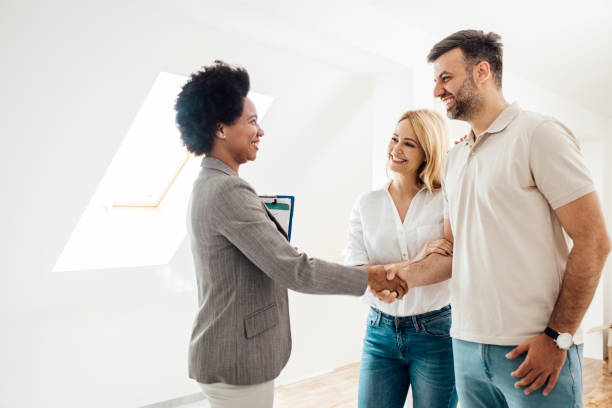 istock Real estate agent shaking hands with her clients after a successful sale 1323020102