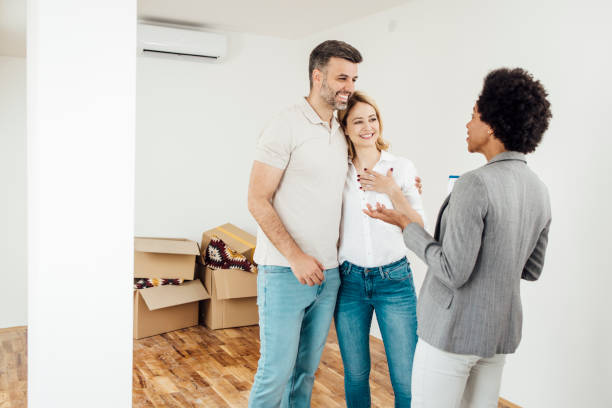 istock Real estate agent talking with her happy buyers 1323020133
