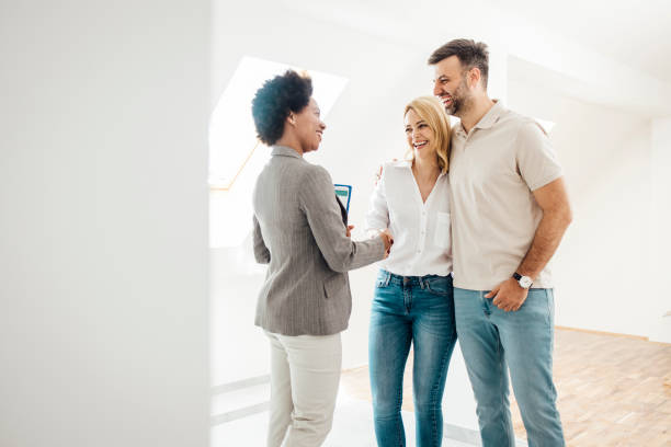 istock Female real estate agent successfully ending a meeting with her clients 1323020139