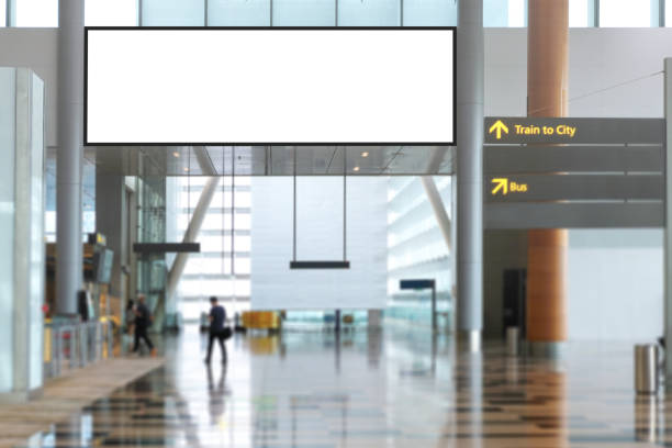 Blank advertising banner, billboard mockup in generic modern interior or airport environment. Large digital display screen, an out-of-home OOH media display space