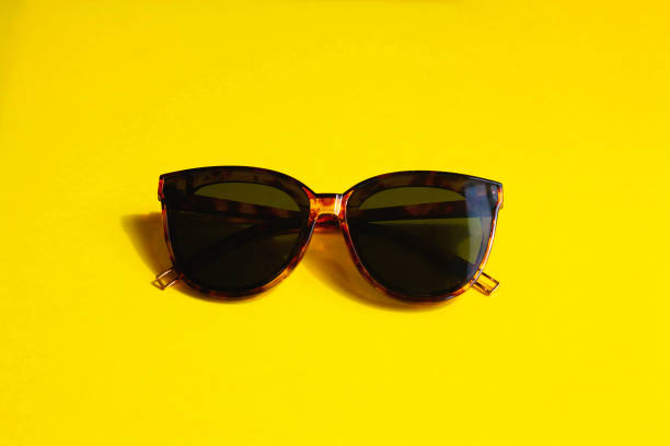 istock Sunglasses on a yellow background 1323021774
