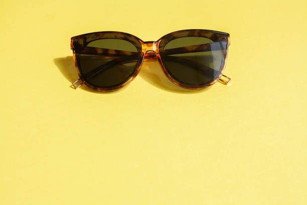 istock Sunglasses on a yellow background, copy space 1323021775
