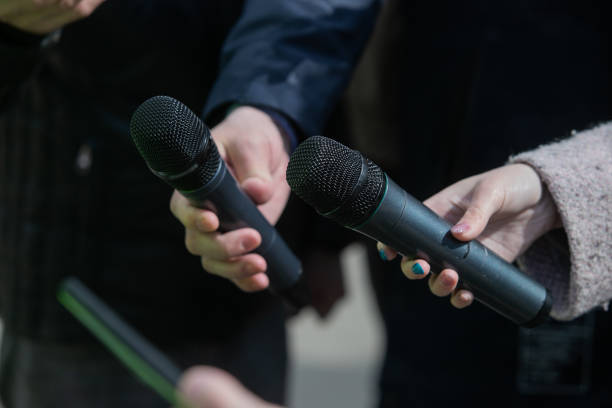 istock Journalist holds a microphone in his hands, interviews 1323021780