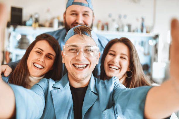 istock Smiling Selfie By Cute Mechanic Friends In Workshop 1323021883