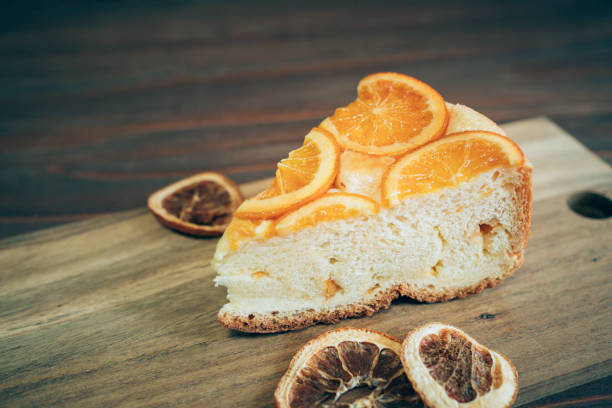 istock Orange flavor custard cake on wooden cutting board. 1323022039