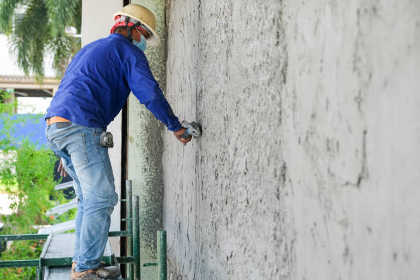 istock Plasterers using trowels mason for plastering and leveling mortar concrete on the brick wall at the construction under building 1323022882