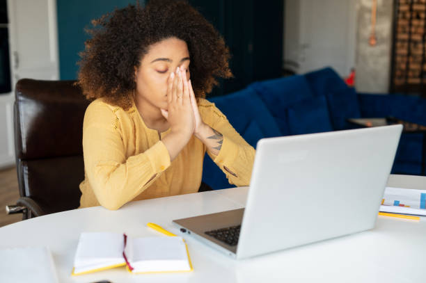 istock Young African-American woman using laptop at home 1323026418