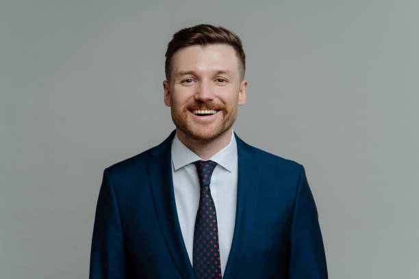 istock Happy professional businessman in suit smiling at camera 1323028697