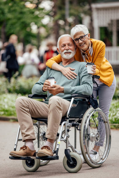 istock Disabled man and his wife, drinking their take-away. 1323028862