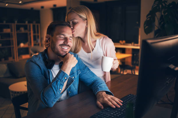 istock Lovely wife supporting her working husband 1323030037